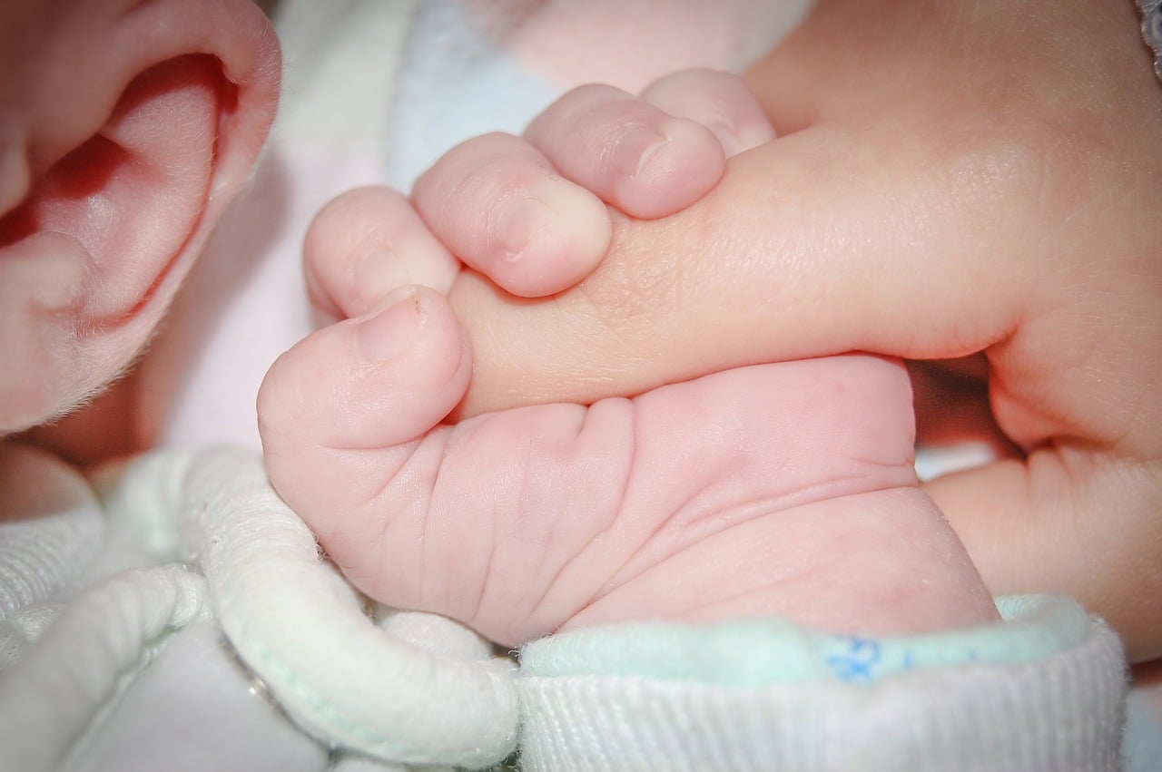 Holding baby hands