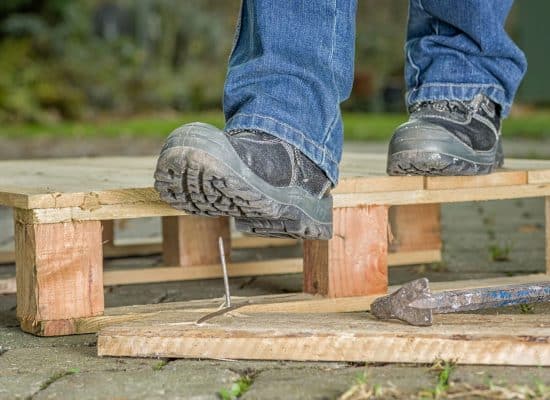 man stepping on the nail