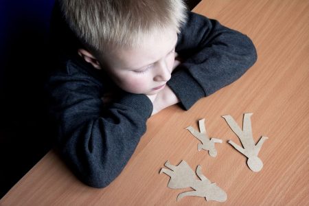 a kid looking at a cutout family board