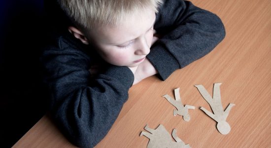 a kid looking at a cutout family board