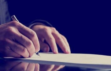 a man signing a document