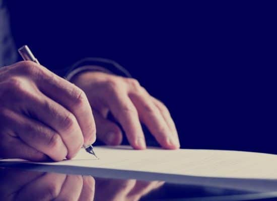 a man signing a document