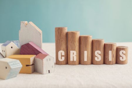 crisis spelled in rows of wooden blocks