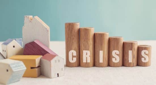 crisis spelled in rows of wooden blocks