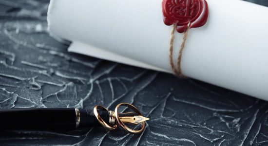 a wax sealed letter with a fountain pen beside it
