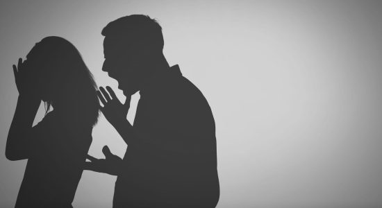 a silhouette of a man shouting to a woman