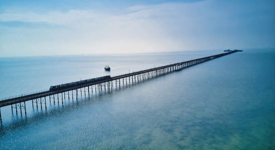 a view of a long pier at sea