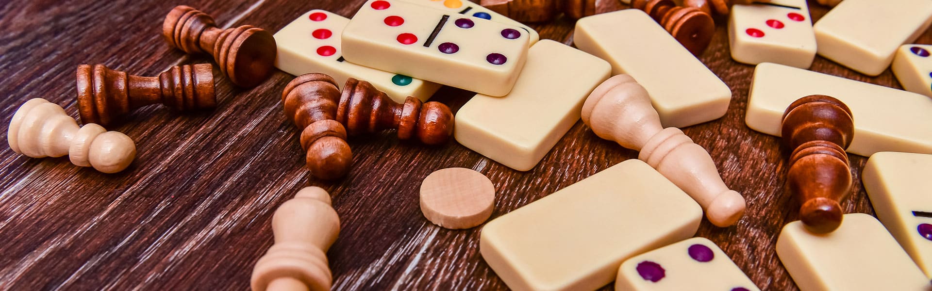 domino and chess pieces on top of a table