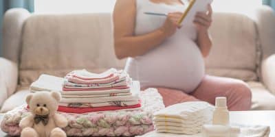 pregnant women listing some baby stuffs