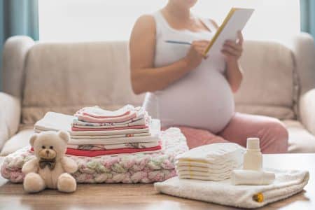 pregnant women listing some baby stuffs