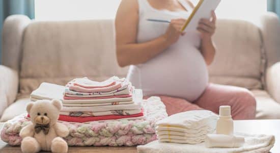 pregnant women listing some baby stuffs